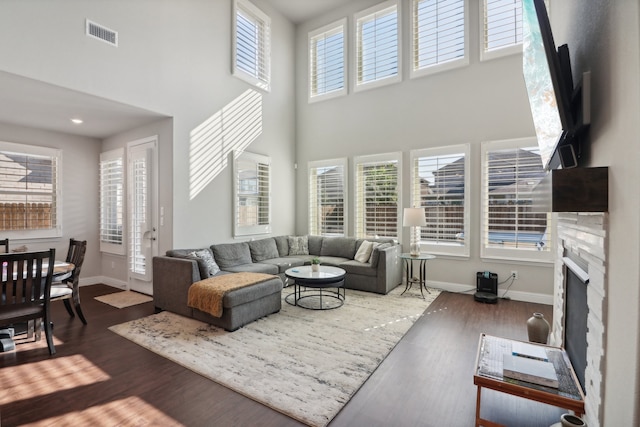 living room with a premium fireplace and dark hardwood / wood-style floors