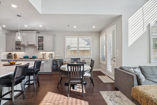 dining space featuring dark hardwood / wood-style flooring and wine cooler