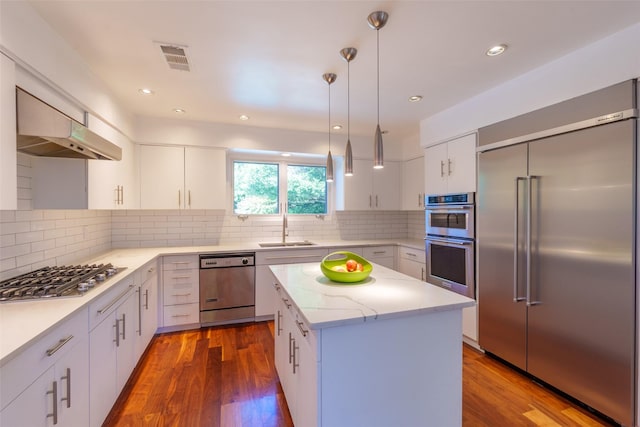 10807 Dove Brook Cir, Dallas, TX 75230 - kitchen with stainless steel appliances, a center island, dark wood finished floors, hanging light fixtures, and recessed lighting
