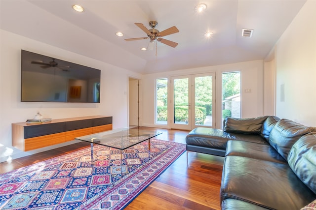 living room featuring hardwood / wood-style floors, ceiling fan, and lofted ceiling