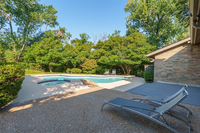 view of swimming pool with a patio area and an in ground hot tub