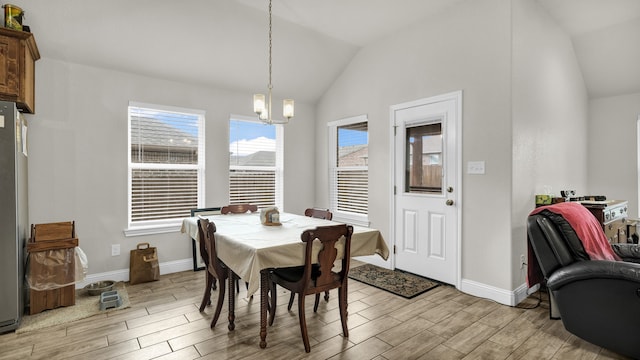 dining area featuring light hardwood / wood-style flooring, vaulted ceiling, and a notable chandelier