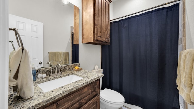 bathroom featuring curtained shower, toilet, and vanity