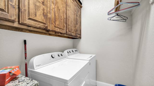 laundry room with cabinets and washing machine and clothes dryer