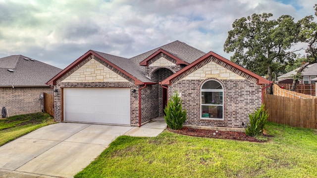 ranch-style house featuring a garage and a front yard