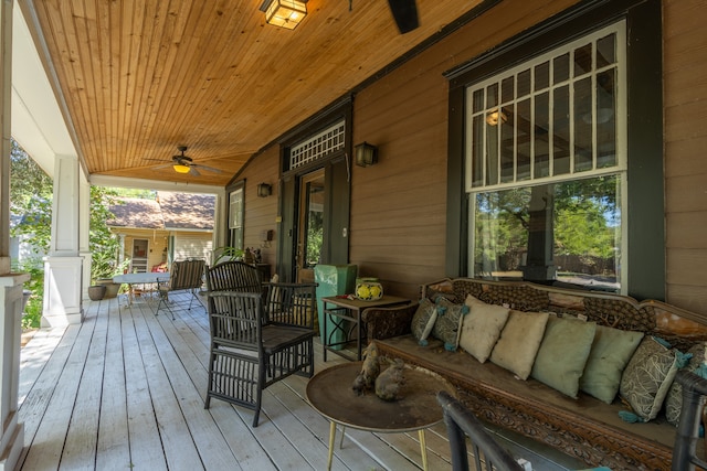 wooden terrace with a porch and ceiling fan