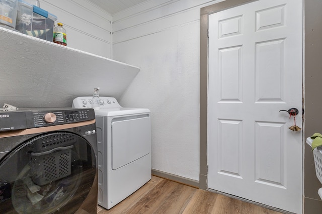 laundry room with light hardwood / wood-style flooring and independent washer and dryer