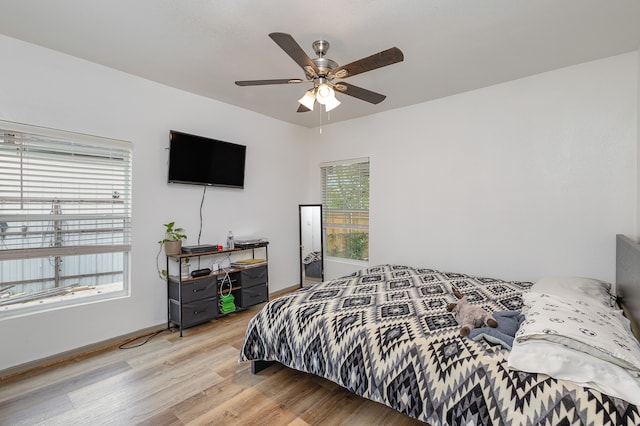 bedroom with hardwood / wood-style floors and ceiling fan