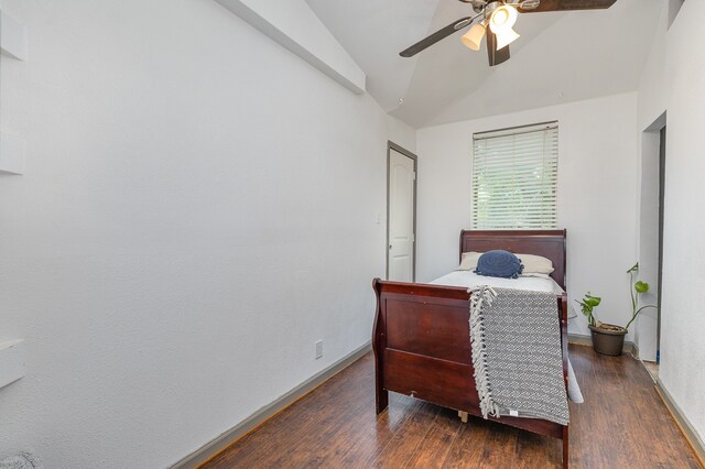 bedroom with dark wood-type flooring, ceiling fan, and vaulted ceiling