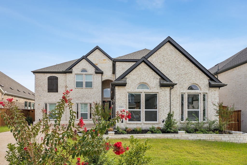 french provincial home featuring a front lawn