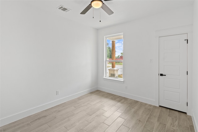 unfurnished room with light wood-type flooring and ceiling fan