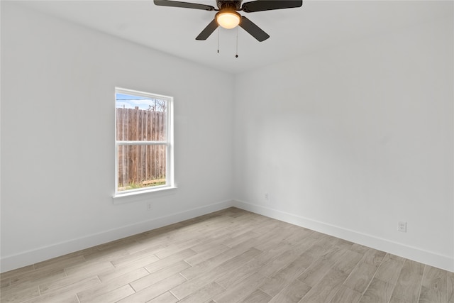 unfurnished room featuring ceiling fan, a wealth of natural light, and light hardwood / wood-style flooring