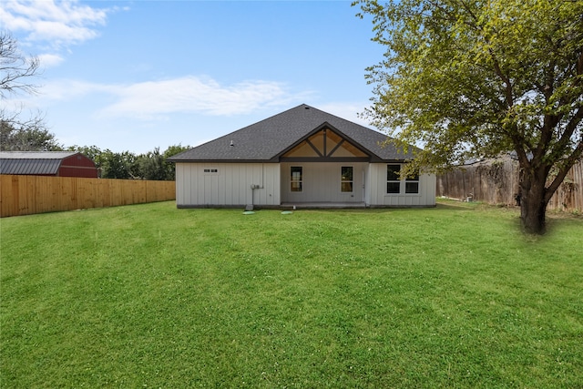 rear view of house featuring a lawn