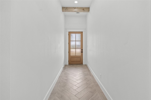 doorway to outside with light parquet flooring and beam ceiling