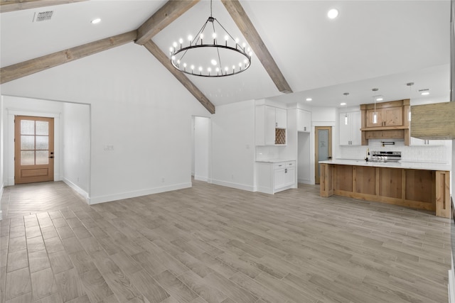 unfurnished living room featuring beam ceiling, a notable chandelier, and light hardwood / wood-style flooring