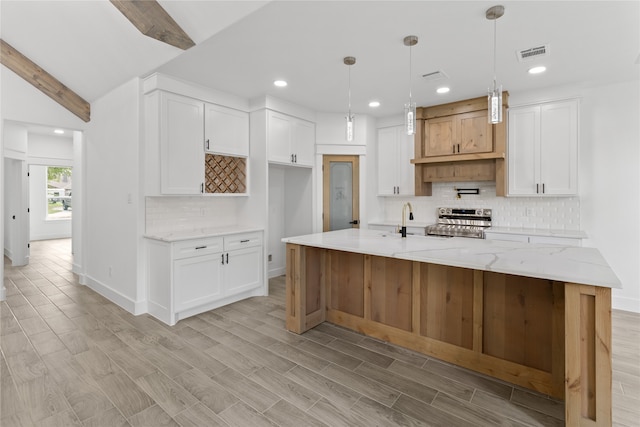 kitchen with hanging light fixtures, light hardwood / wood-style flooring, light stone countertops, electric range, and white cabinetry