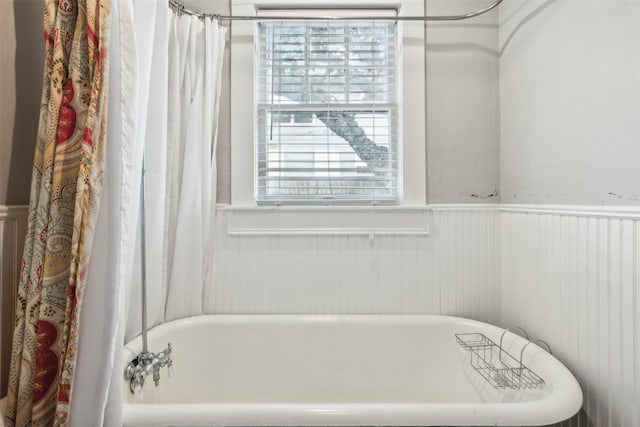 bathroom with shower / bath combo with shower curtain