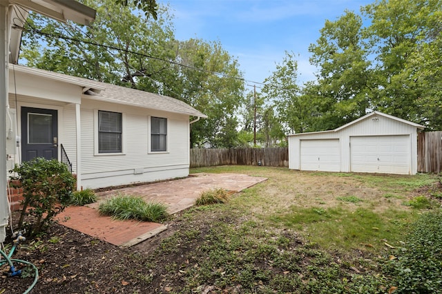 view of yard featuring a patio and a garage