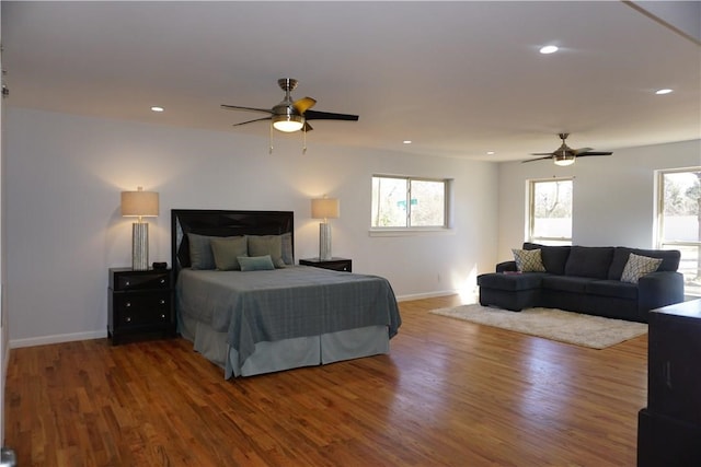 bedroom with ceiling fan and dark hardwood / wood-style floors