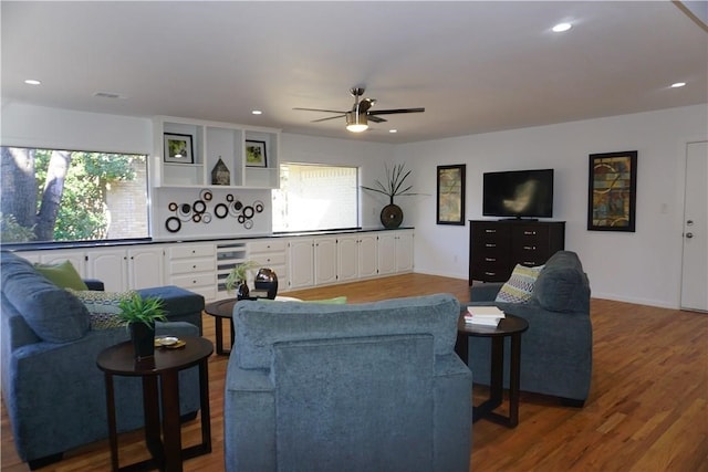 living room with ceiling fan and dark hardwood / wood-style floors