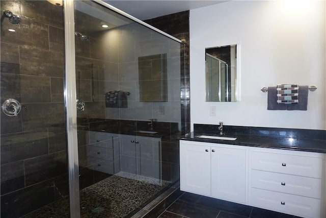 bathroom with vanity, tile patterned flooring, and a shower with door