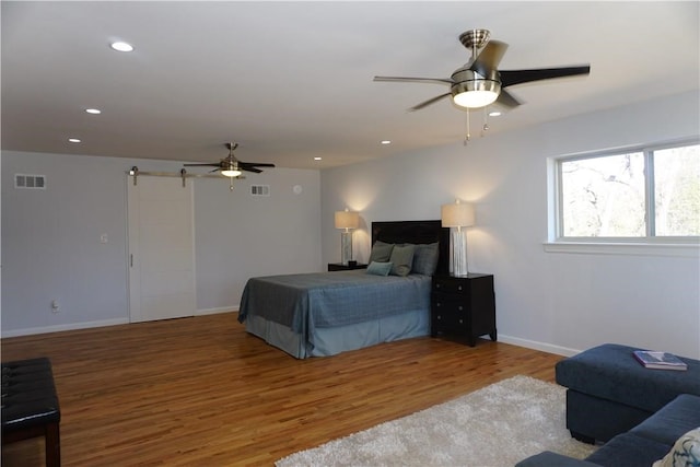 bedroom featuring hardwood / wood-style floors and ceiling fan