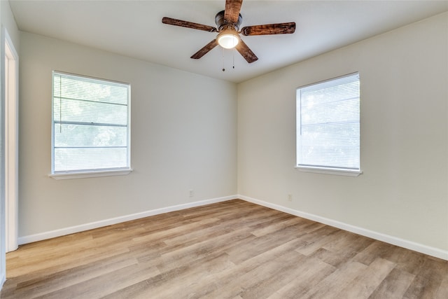 unfurnished room with plenty of natural light, ceiling fan, and light hardwood / wood-style flooring