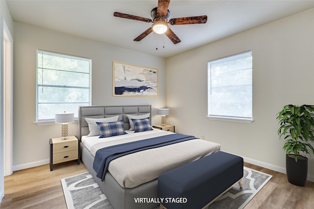 bedroom with light wood-type flooring and ceiling fan