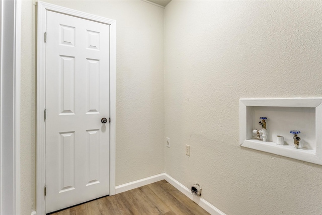 clothes washing area with electric dryer hookup and hardwood / wood-style floors