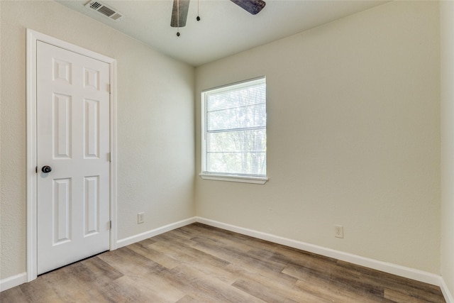 unfurnished room with ceiling fan and light wood-type flooring