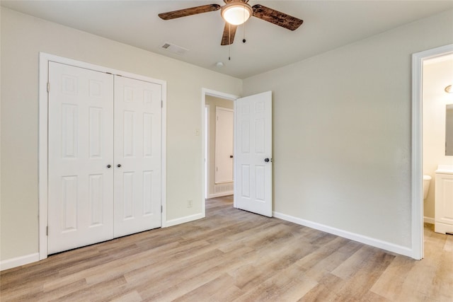 unfurnished bedroom with ceiling fan, a closet, connected bathroom, and light hardwood / wood-style flooring