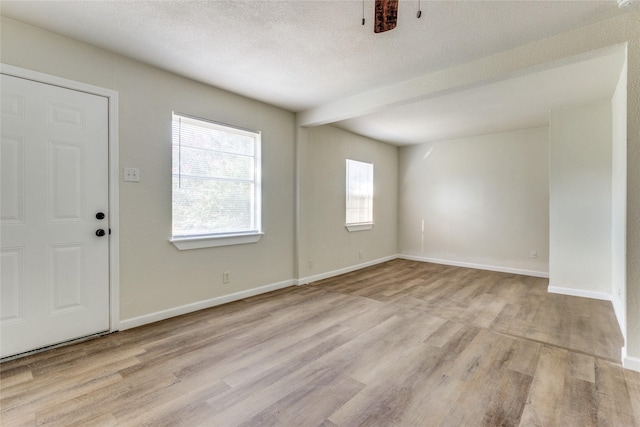 entrance foyer featuring light hardwood / wood-style flooring and a textured ceiling