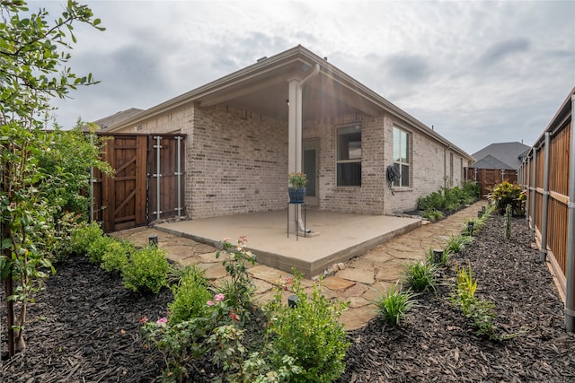 rear view of property featuring a patio