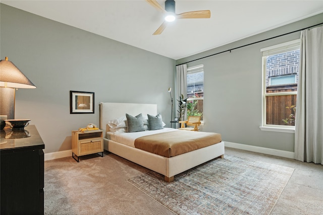 carpeted bedroom featuring ceiling fan and multiple windows