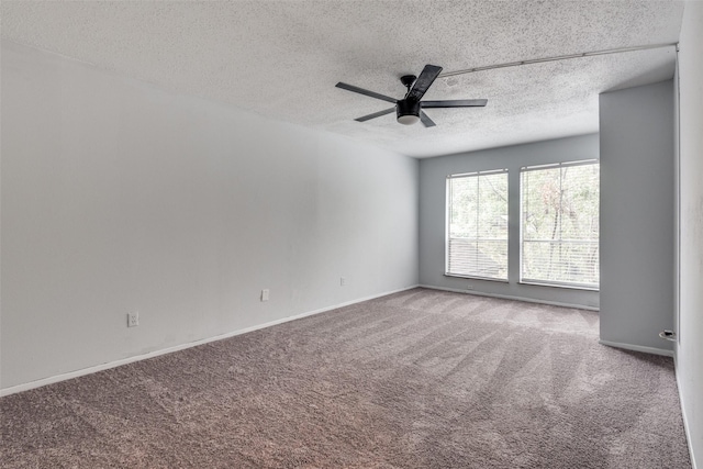 carpeted spare room with ceiling fan, baseboards, and a textured ceiling