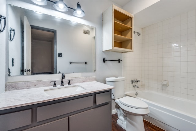 full bathroom with vanity, toilet, tiled shower / bath combo, and hardwood / wood-style floors