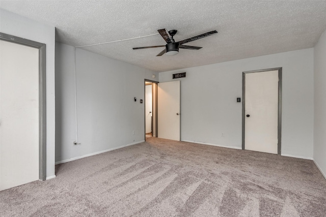 unfurnished bedroom with a textured ceiling, ceiling fan, carpet, and visible vents