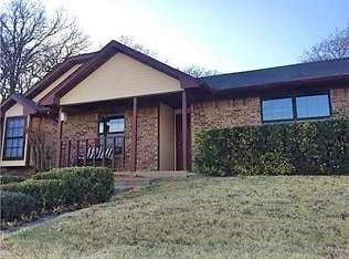 ranch-style home featuring a front yard