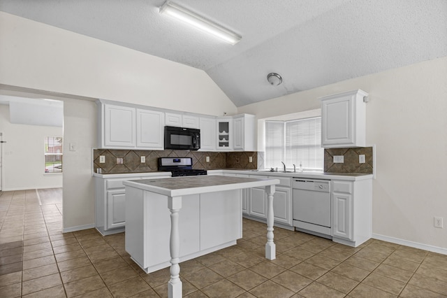 kitchen featuring white cabinetry, white dishwasher, and stainless steel stove