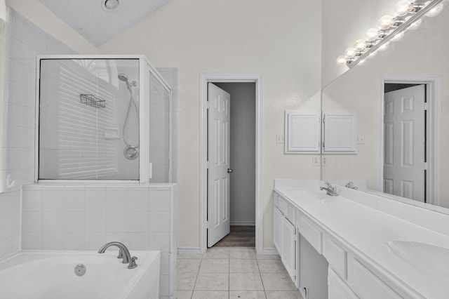 bathroom with vanity, vaulted ceiling, independent shower and bath, and tile patterned floors