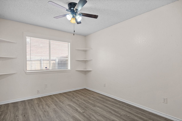 spare room featuring a textured ceiling, ceiling fan, and wood-type flooring