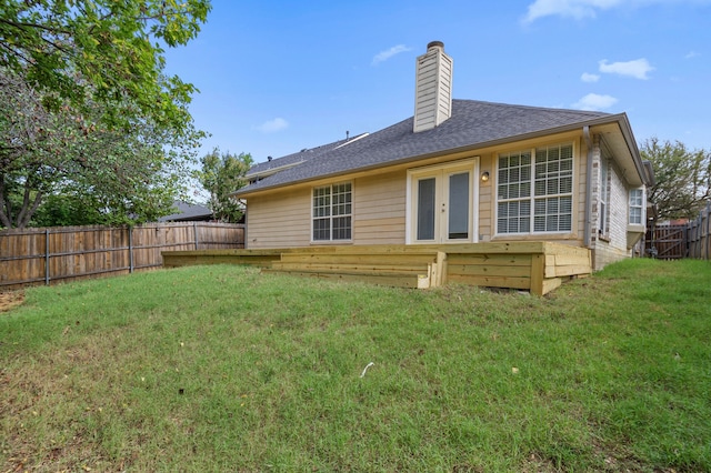 rear view of property with a lawn