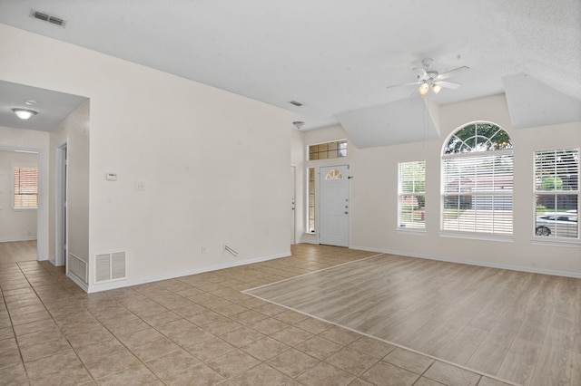 interior space with light wood-type flooring, ceiling fan, and a textured ceiling