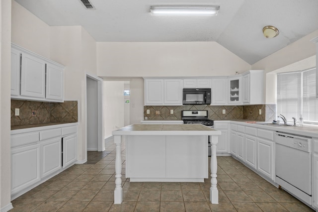 kitchen with white dishwasher, a kitchen island, backsplash, and a kitchen bar