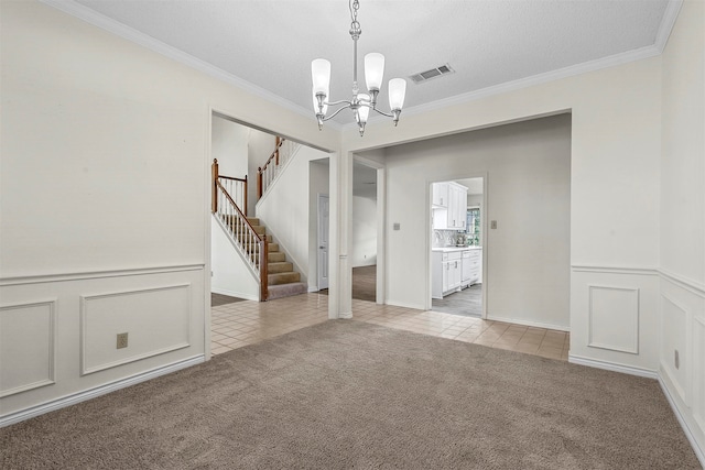 interior space featuring a textured ceiling, a notable chandelier, crown molding, and light carpet