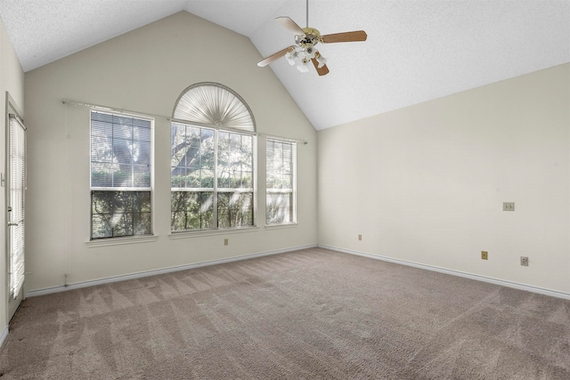 carpeted empty room featuring high vaulted ceiling and ceiling fan