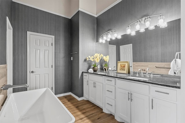 bathroom featuring vanity, hardwood / wood-style flooring, and a tub