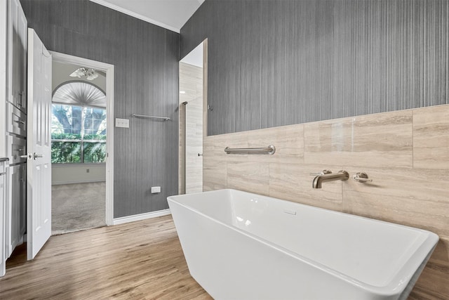 bathroom with hardwood / wood-style floors and a tub