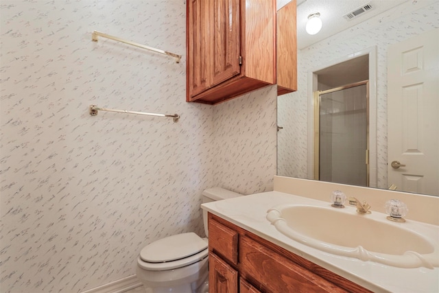 bathroom with vanity, toilet, and walk in shower