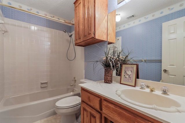 full bathroom featuring vanity, a textured ceiling, bathing tub / shower combination, and toilet